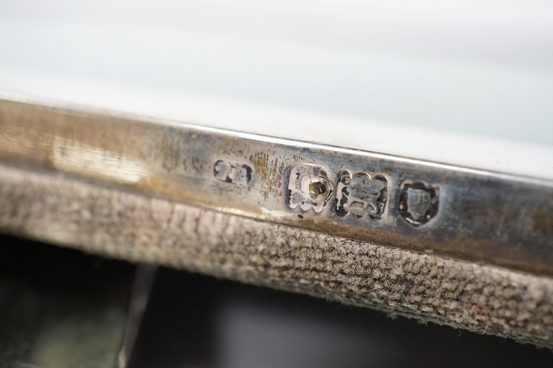 Three assorted early 20th century silver mounted photograph frames, including Birmingham, 1916, (some marks rubbed), largest 27cm. Condition - poor to fair